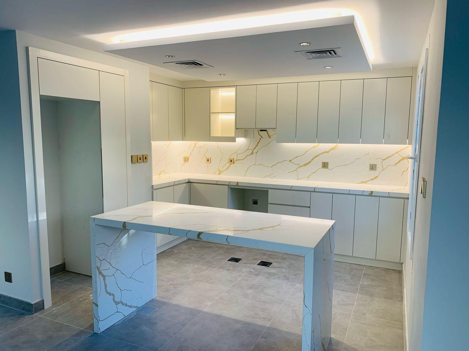 Kitchen Renovation Dubai 1 Completed villa kitchen renovation Dubai — white cabinetry with Calacatta gold marble island by ASM Interiors