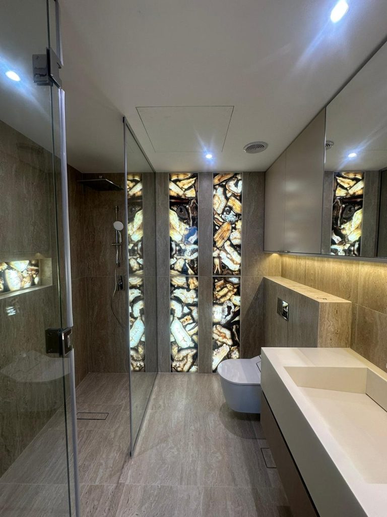 Bathroom renovation with backlit precious stone feature at Canal Front CF09A by ASM Interiors