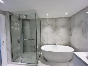 Bathtub and shower glass at Palm Jumeirah Marina Residence 6 by ASM Interiors