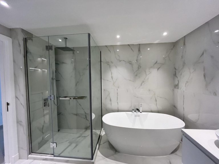 Bathtub and shower glass at Palm Jumeirah Marina Residence 6 by ASM Interiors