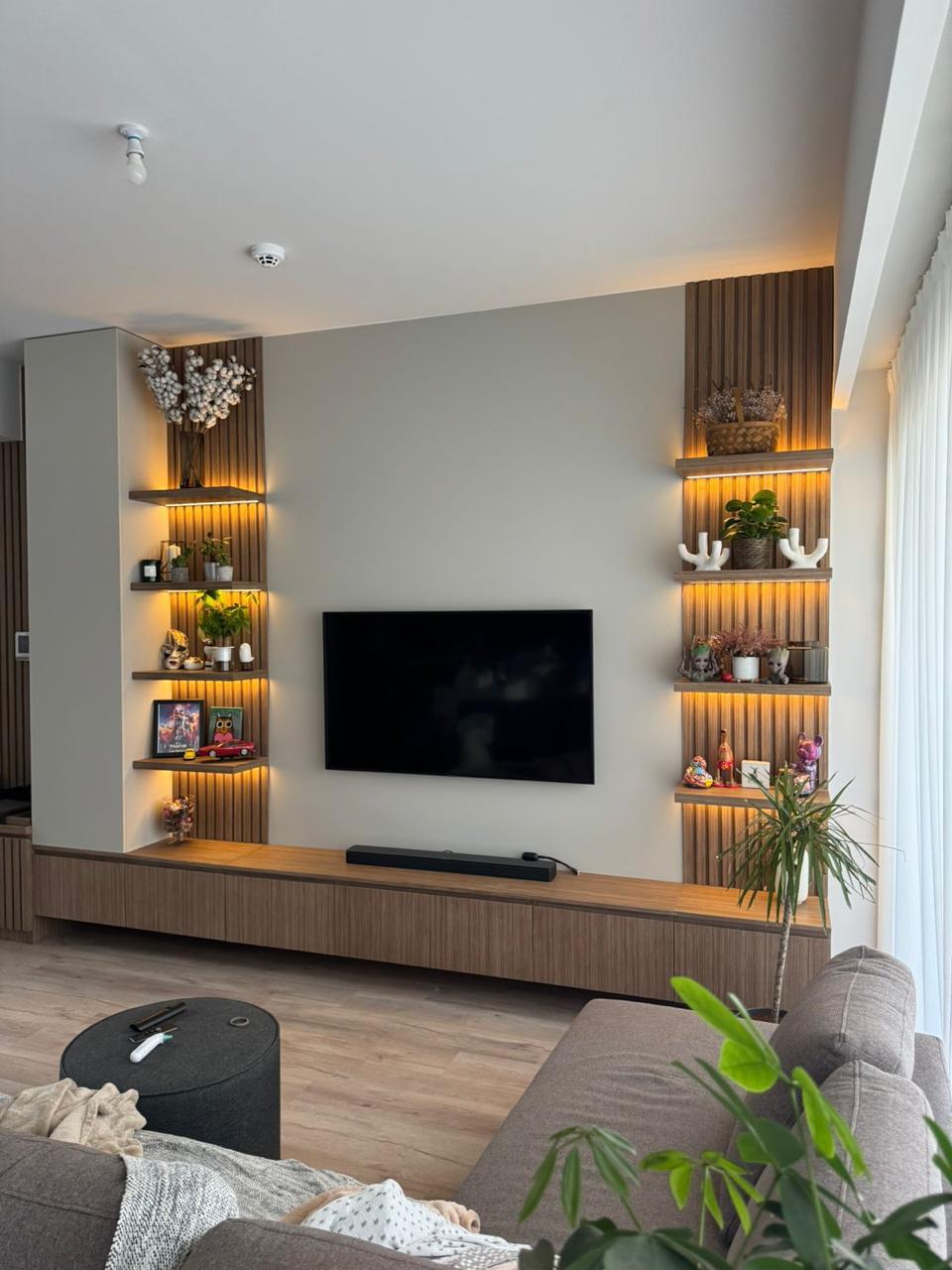 TV wall with storage cabinetry by ASM Interiors Dubai