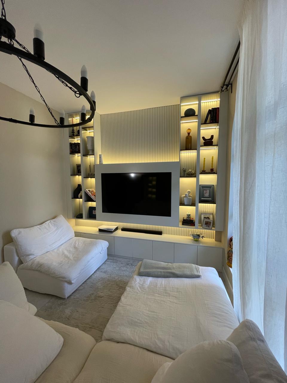 TV wall with storage cabinetry by ASM Interiors Dubai