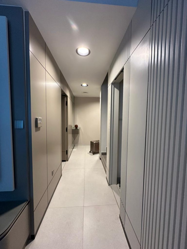 Projects We Have Done 81 Custom wardrobe corridor with fluted-panel detailing for a private villa in Dubai by ASM Interiors