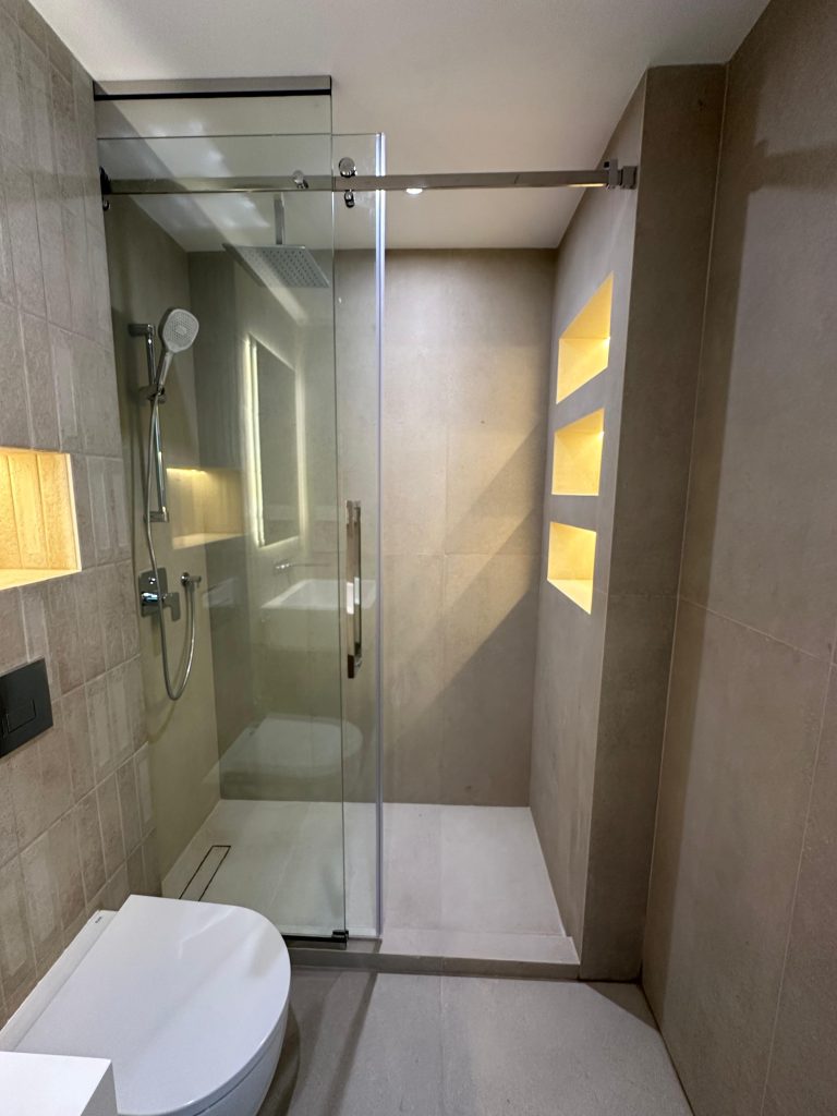 Paloma Tower, Marina Promenade – Apartment Renovation Project 6 Walk-in shower with sliding glass door and lit niches, Paloma Tower, Dubai Marina