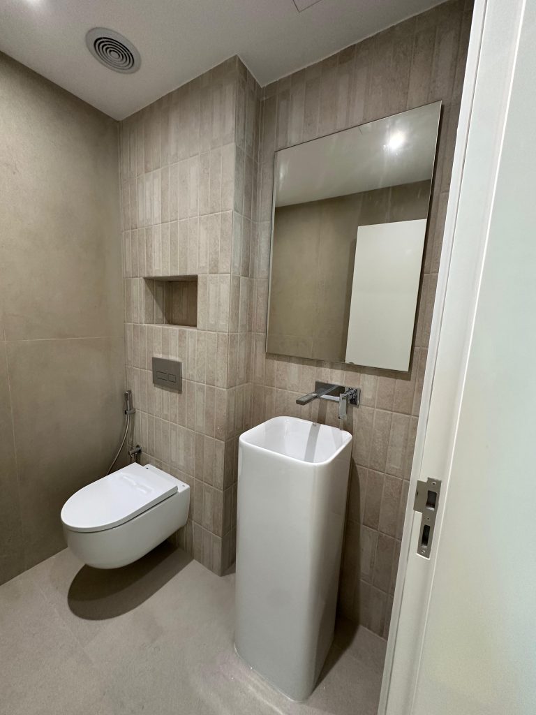 Paloma Tower, Marina Promenade – Apartment Renovation Project 7 Guest WC with pedestal basin and wall-hung toilet, Paloma Tower, Dubai Marina