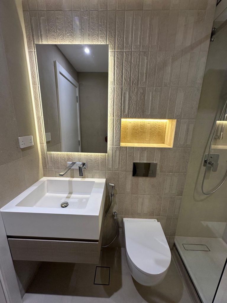 Paloma Tower, Marina Promenade – Apartment Renovation Project 5 Bathroom vanity with backlit mirror and lit wall niche, Paloma Tower, Dubai Marina