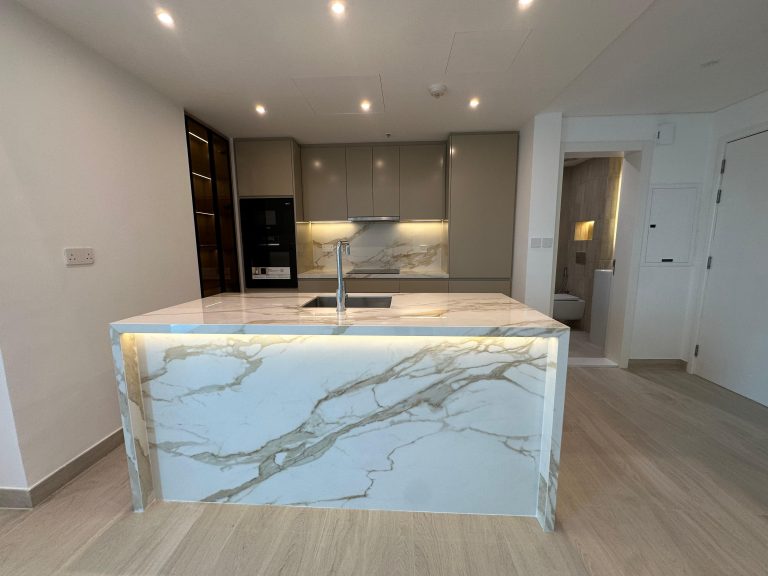 Backlit stone island in the renovated kitchen at Paloma Tower, Marina Promenade, Dubai Marina by ASM Interiors