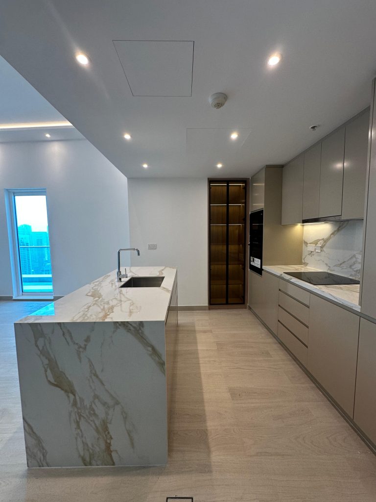 Home 8 Renovated apartment kitchen with stone island and handleless cabinetry at Paloma Tower, Marina Promenade, Dubai Marina