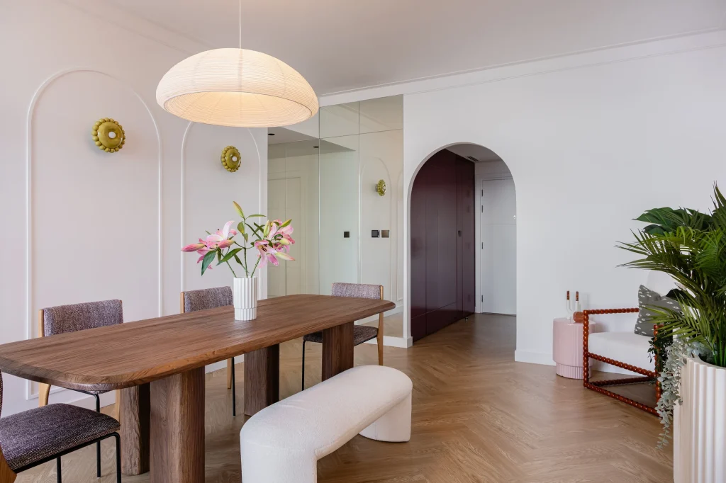 Projects We Have Done 16 Dining area with curved wall mouldings, an arched doorway and herringbone-pattern flooring.