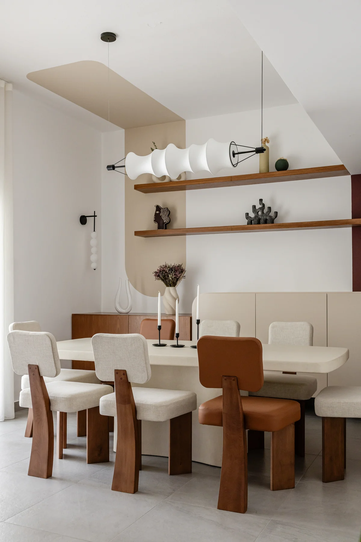 Jumeirah Interior & Joinery 2 Dining area with open shelves, upholstered seating and a sculptural pendant light.