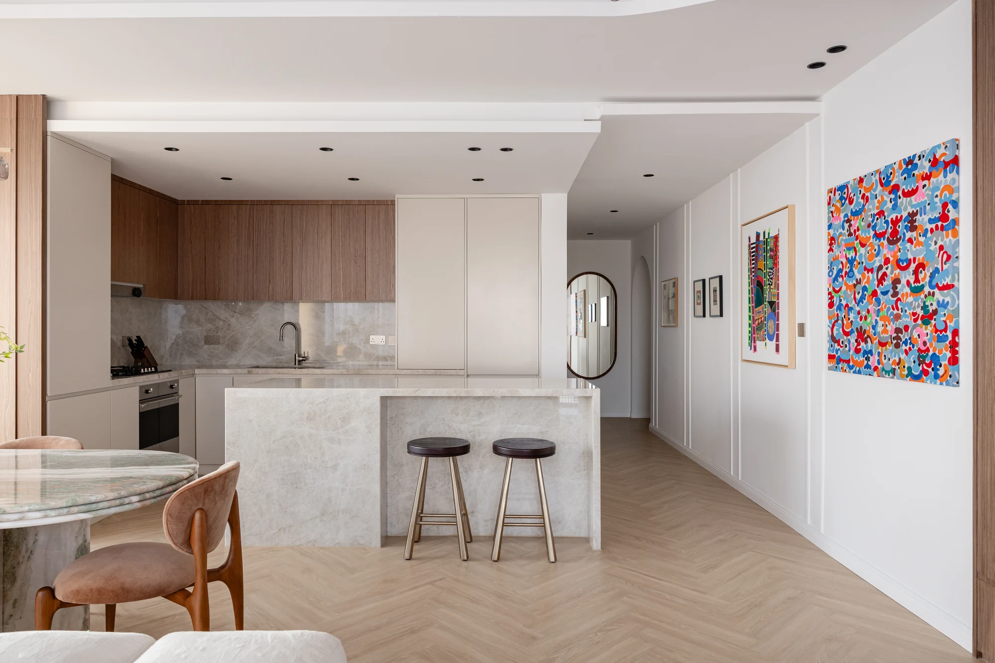 Opera Grand Apartment Renovation – Downtown Dubai 2 Two-tone kitchen cabinetry and stone island at Opera Grand, Downtown Dubai