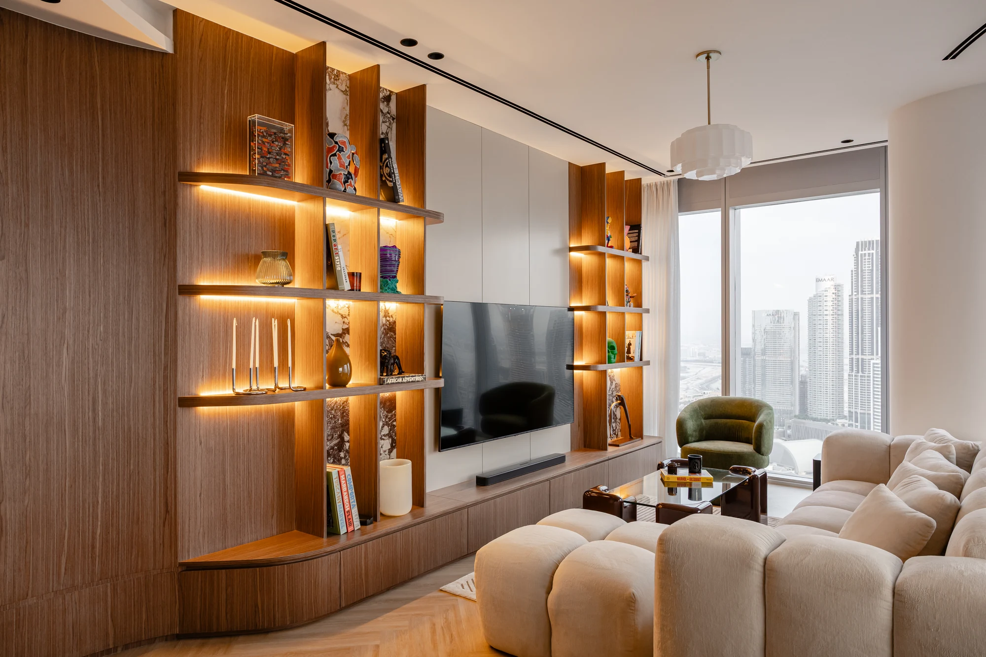 Opera Grand Apartment Renovation – Downtown Dubai 1 Illuminated timber shelving and living-room joinery at Opera Grand, Downtown Dubai